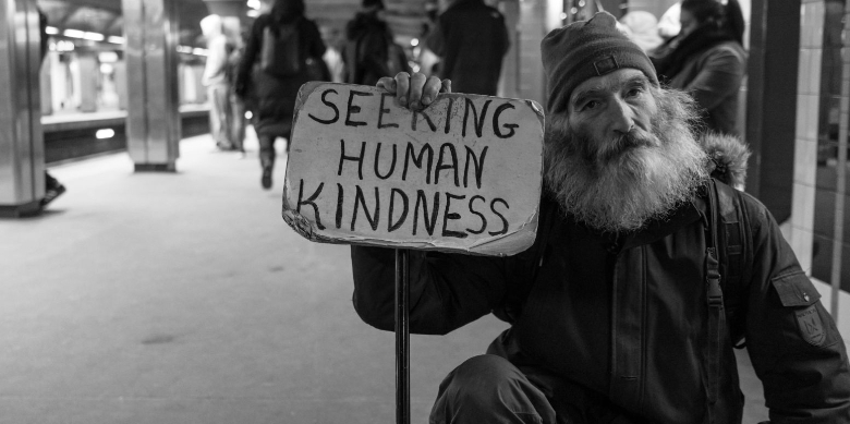 man with a sign that says "seeking human kindness"